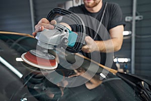 Mechanic hands holding car polish at auto repair shop