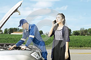 Mechanic with his panicky customer on roadside