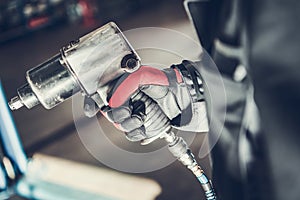 Mechanic Holding Pneumatic Wrench Gun