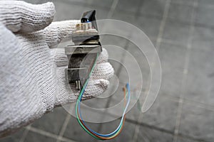 Mechanic holding a Speed Sensor for car