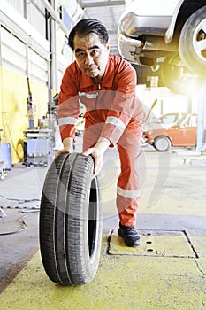 Mechanic holding a tire at the repair garage