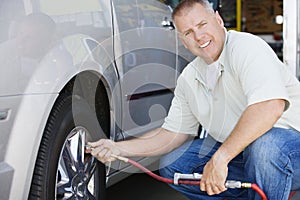 Mechanic Inflating RV~s Tire