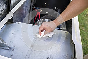 Mechanic Inspecting or checking the generator. Tiding up after engine oil change