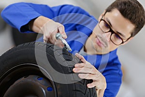 Mechanic inspecting a wheel