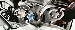 A mechanic is installing a car circle-shaped LPG or Propane tank in a spare wheel hole