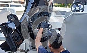 Mechanic is installing speed boat engine