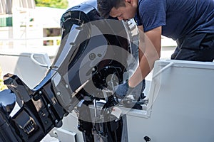 Mechanic is installing speed boat engine