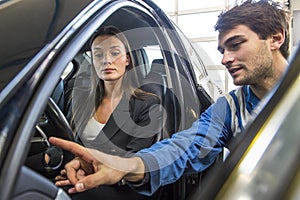 Mechanic instructing a customer