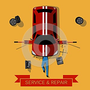 Mechanic lies under the car and repairs it: Car repair and service concept