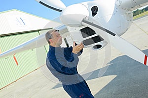 Mechanic looking at aircraft propellor