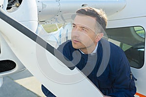 Mechanic looking at aircraft propellor photo