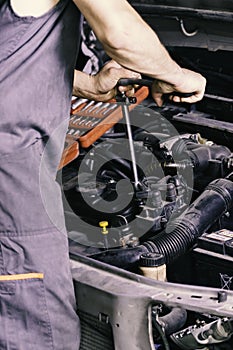 Mechanic looking at a red tool photo