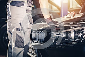 Mechanic Looking Under Sport Car Bonnet