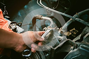 Mechanic maintenance small business service, Man hold wrench unscrewing  concept repair the car. Instagram style filter photo
