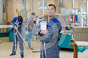 Mechanic man holding pen and folder