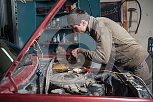 Mechanic man worker pouring antifreeze in the cooling system