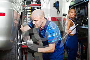 Mechanic man working with tire