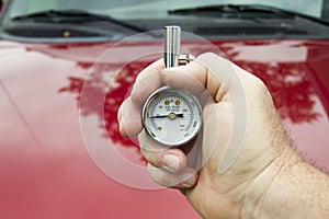 Mechanic Measuring PSI Levels In A Tire