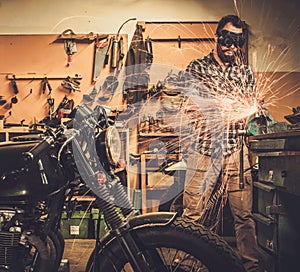 Mechanic at motorcycle customs garage