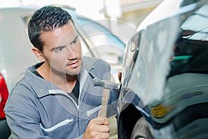 Mechanic panel beating car