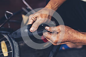 The mechanic patched the inner tube of the bicycle with glue and patch