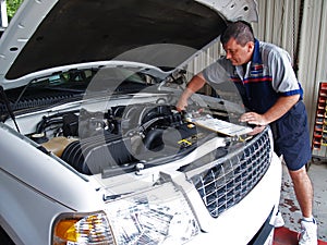 Mechanic Performing a Routine Service Inspection