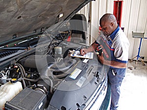 Mechanic Performing a Routine Service Inspection
