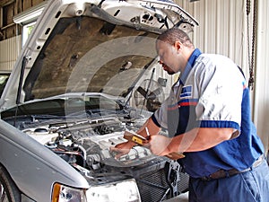 Mechanic Performing a Routine Service Inspection