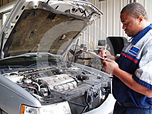 Mechanic Performing a Routine Service Inspection