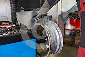 Mechanic preparing wheel for tire mounting