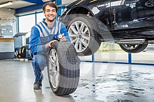 Mechanic Pressing Gauge Into Tire Tread In Garage