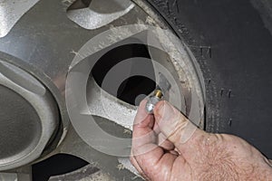 Mechanic Putting On A New Aluminum Air Valve Stem Cap