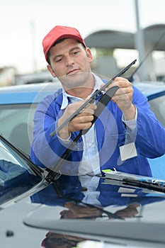 Mechanic ready to change windscreen wiper or mechanic