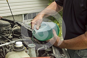 Mechanic Refilling Windshield Wiper Fluid In A Car