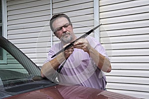 Mechanic Removing Worn Out Windshield Wipers