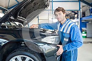 Mechanic Repairing Car Engine In Garage