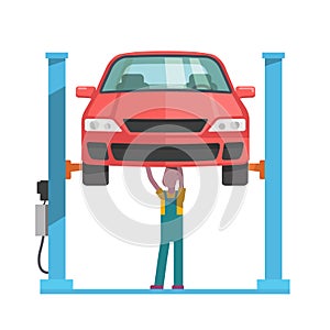 Mechanic repairing a car lifted on auto hoist