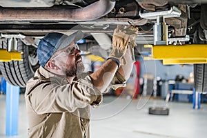 Mechanic Repairing Car Undercarriage