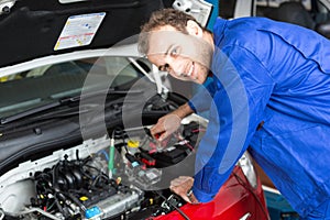 Mechanic repairing a car in a workshop or garage