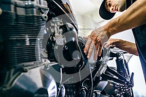 Mechanic repairing customized motorcycle