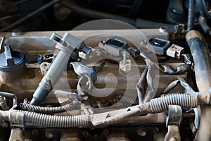 mechanic repairing ignition coil on gasoline engine