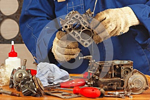 Mechanic repairing old car engine carburetor photo