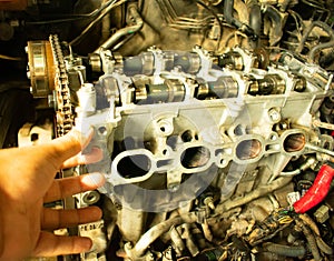 Mechanic repairman checking open engine in automobile center