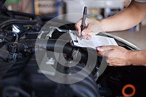 Mechanic repairman inspecting car