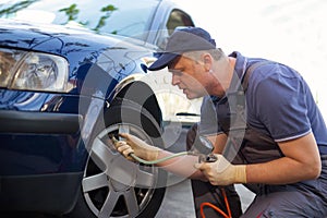 Mechanic repairman making tyre in workshop