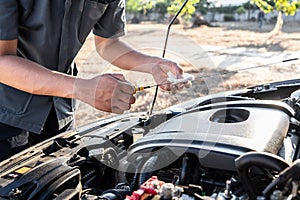 Mechanic repairman working in engine automotive in auto repair service and checking oil, Service and Maintenance car check