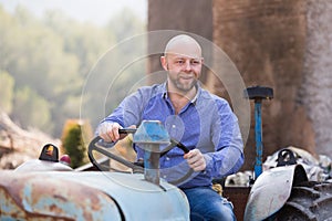 Mechanic reparing old agrimotors at farm