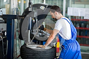 Mechanic replace tires on wheels photo