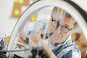 mechanic replacing wheel on bicycle