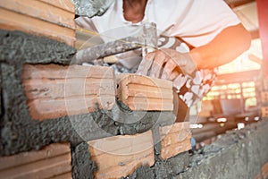 Mechanic`s hand Holding bricks in construction projects